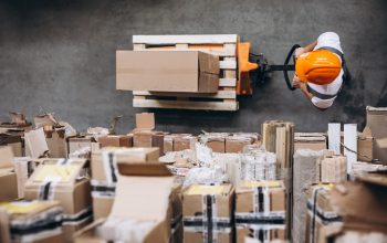 Young man working at a warehouse with boxes